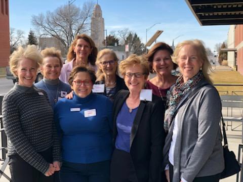 Group of League of Women Voters standing in front of the Lincoln Nebraska capitol building to help volunteer